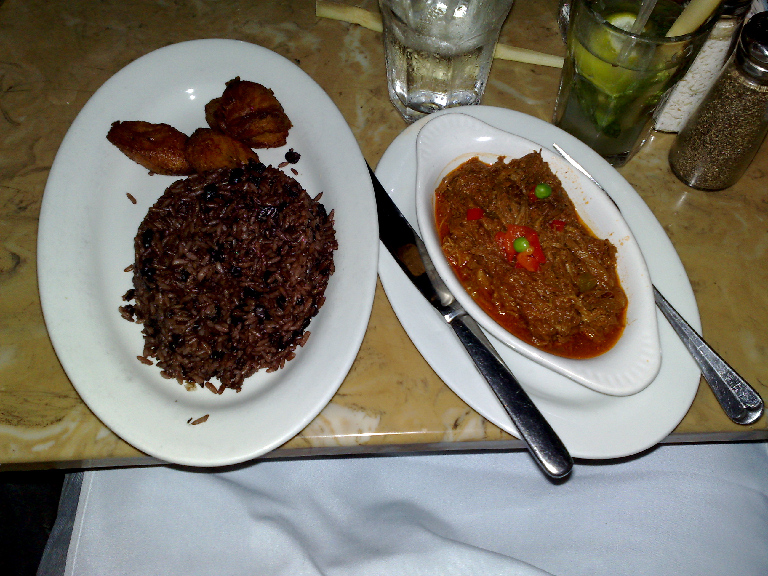Traditional Cuban cuisine - ropa vieja, moros y cristianos, and tostones